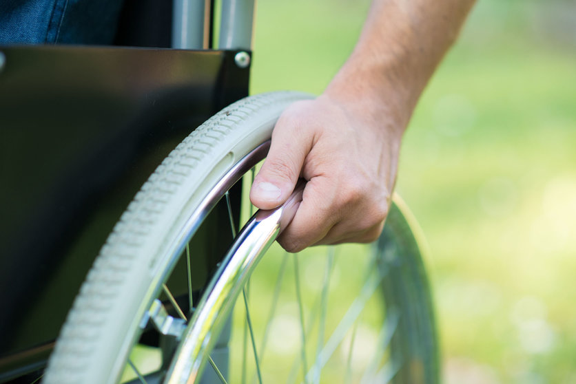 42245794 - detail of a man using a wheelchair in a park