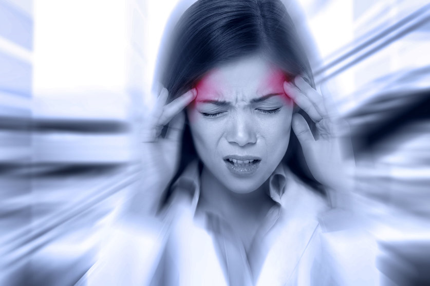 34944243 - headache migraine people - doctor woman stressed. woman nurse / doctor with migraine headache overworked and stressed. health care professional in lab coat wearing stethoscope at hospital.