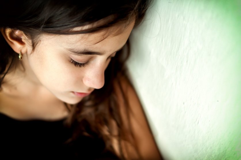 16795222 - emotional portrait of a sad girl with a shallow depth of field and space for text