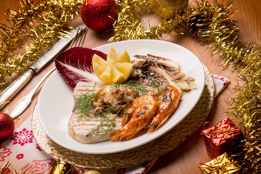 63227872 - mixed grilled fish with red chicory over christmas table