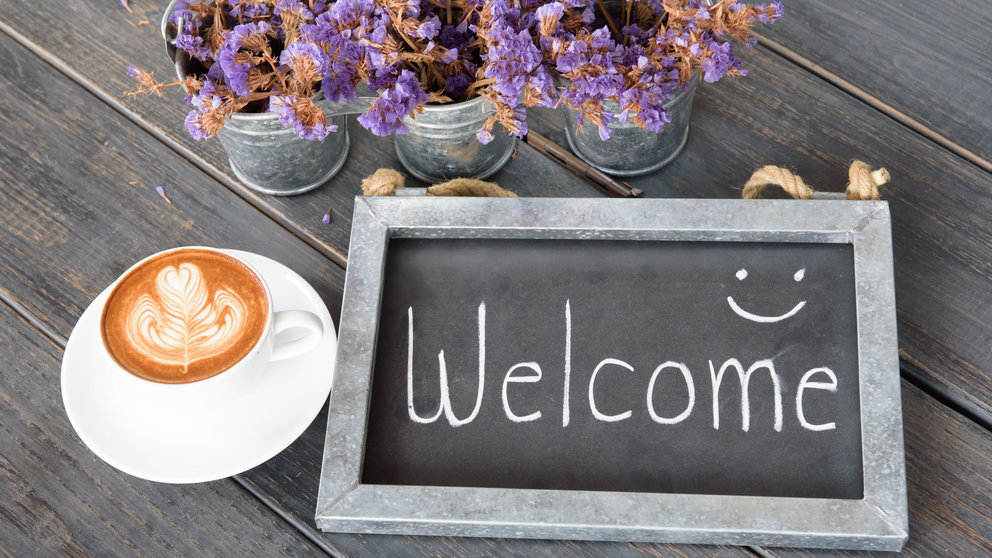 50206846 - wooden vintage frame welcome next to coffee cup