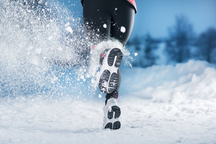17425312 - athlete woman is running during winter training outside in cold snow weather